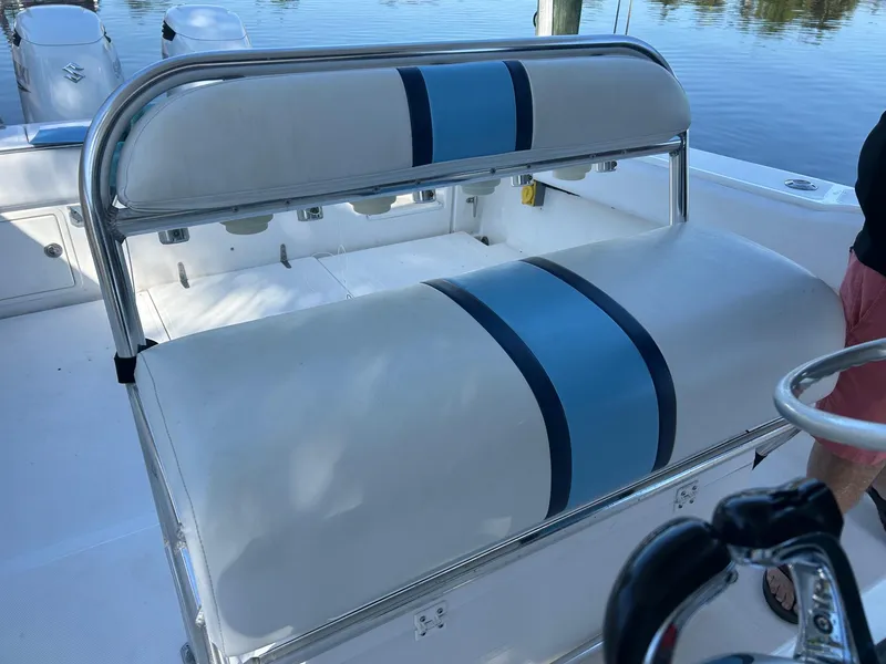 Slide: The Image of 2002 Venture 34 Center Console boat seating with blue-striped upholstery. - 22