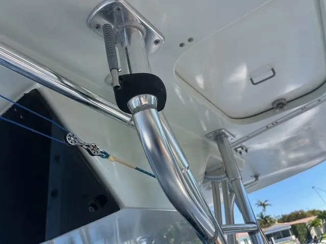 Slide: The Image of 2002 Venture 34 Center Console boat with stainless steel rod holder and rigging. - 27