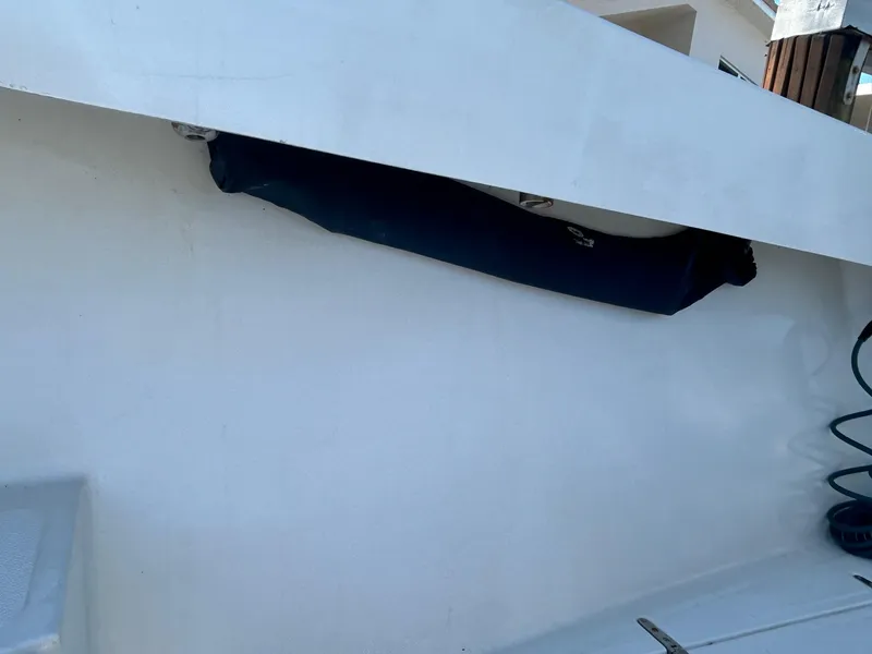 Slide: The Image of 2002 Venture 34 Center Console boat detail with covered equipment and coiled cable. - 33