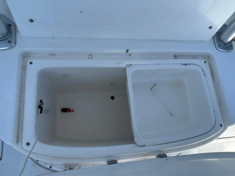 Slide: The Image of Open storage compartment on a 2002 Venture 34 Center Console boat. - 35