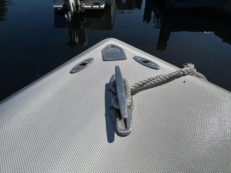 Slide: The Image of Bow of 2002 Venture 34 Center Console boat with cleat and rope. - 36
