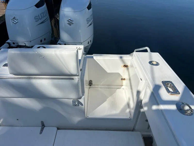 Slide: The Image of 2002 Venture 34 Center Console boat with Suzuki engines, featuring a spacious deck and storage compartment. - 6