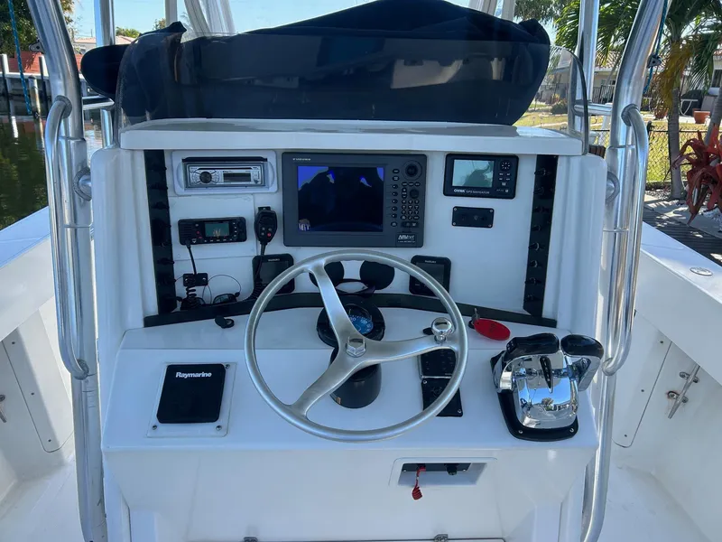 Slide: The Image of Center console of 2002 Venture 34 boat with steering wheel and navigation equipment. - 9