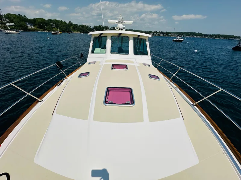 Slide: The Image of 2008 Sabre 42 Hardtop Express yacht on calm water, clear sky, scenic background. - 10