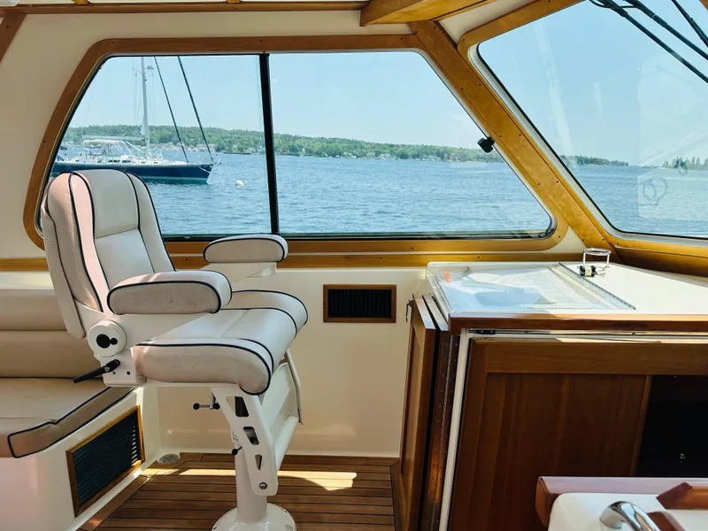 Slide: The Image of 2008 Sabre 42 Hardtop Express interior with helm seat and ocean view. - 12