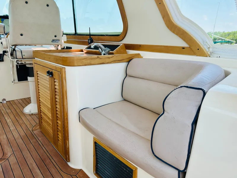 Slide: The Image of 2008 Sabre 42 Hardtop Express interior with beige seating and wooden accents. - 13