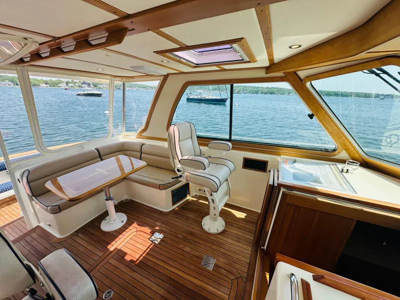 Slide: The Image of Interior of 2008 Sabre 42 Hardtop Express yacht with wood finish and scenic water view. - 14