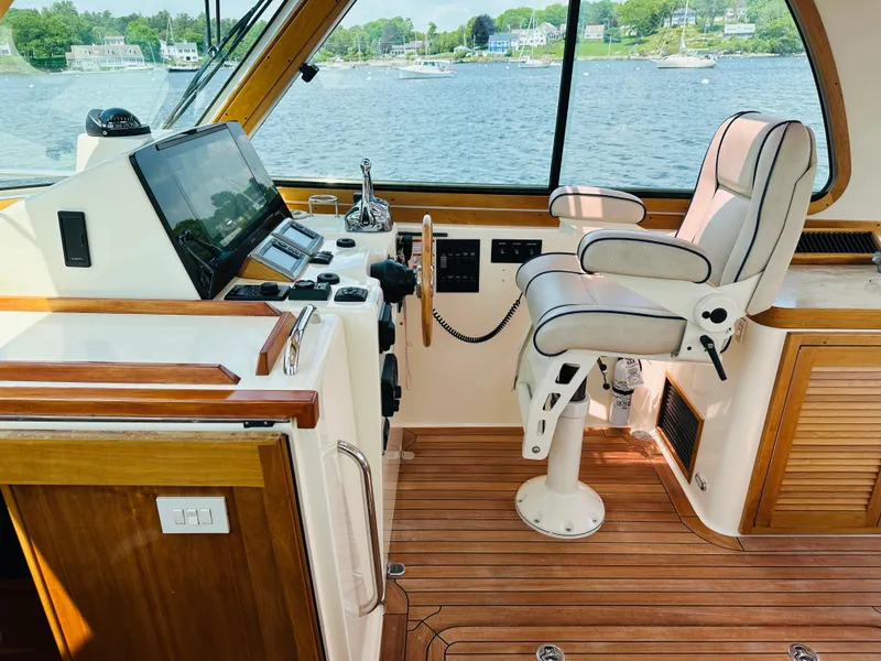 Slide: The Image of 2008 Sabre 42 Hardtop Express helm with captain's chair and navigation equipment, overlooking water. - 17