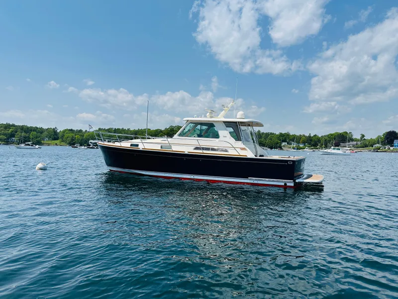 Slide: The Image of 2008 Sabre 42 Hardtop Express yacht on calm water under blue sky. - 2