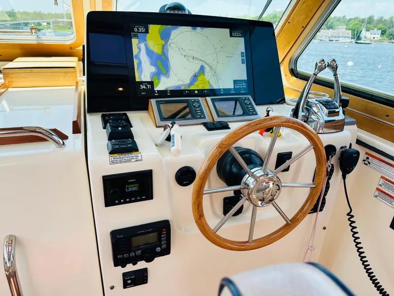 Slide: The Image of Helm of 2008 Sabre 42 Hardtop Express with navigation screens and wooden steering wheel. - 20
