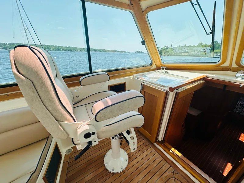 Slide: The Image of 2008 Sabre 42 Hardtop Express interior with captain's chair and scenic water view. - 23
