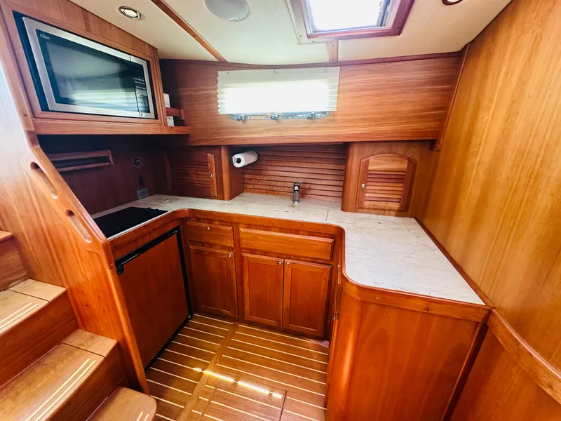 Slide: The Image of 2008 Sabre 42 Hardtop Express galley with wood cabinetry and modern appliances. - 27