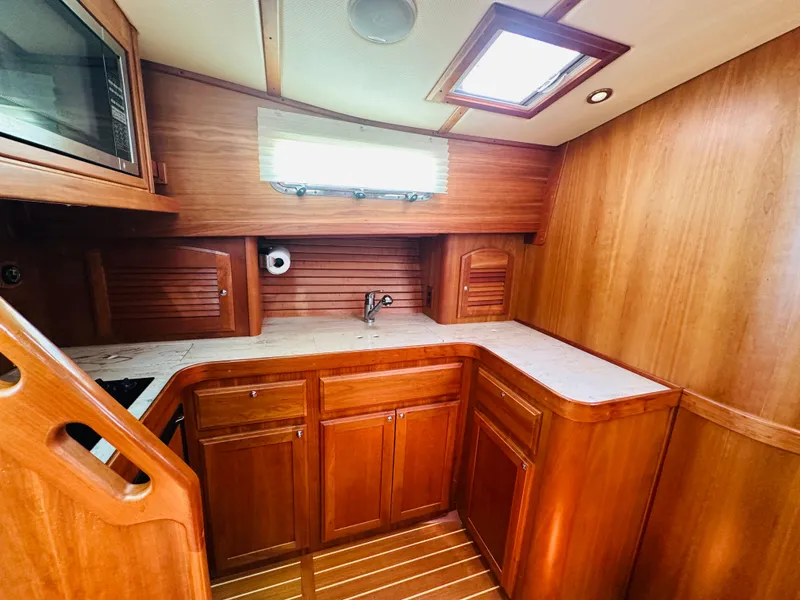 Slide: The Image of 2008 Sabre 42 Hardtop Express yacht interior with wooden cabinetry and countertop. - 30