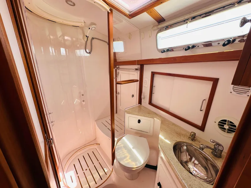 Slide: The Image of 2008 Sabre 42 Hardtop Express bathroom with shower, sink, and toilet in a compact layout. - 44