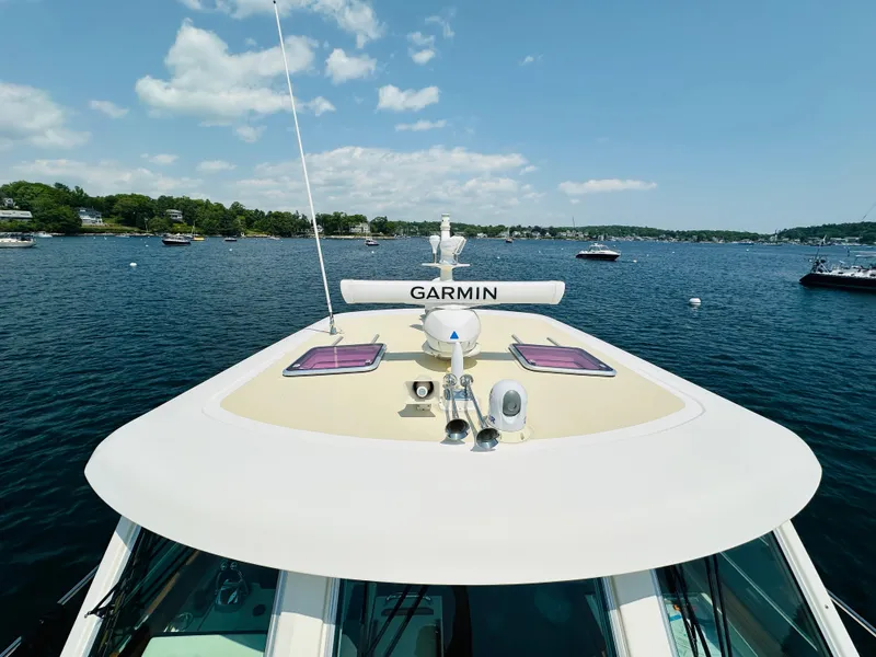 Slide: The Image of 2008 Sabre 42 Hardtop Express yacht on water, featuring Garmin equipment, under clear sky. - 9