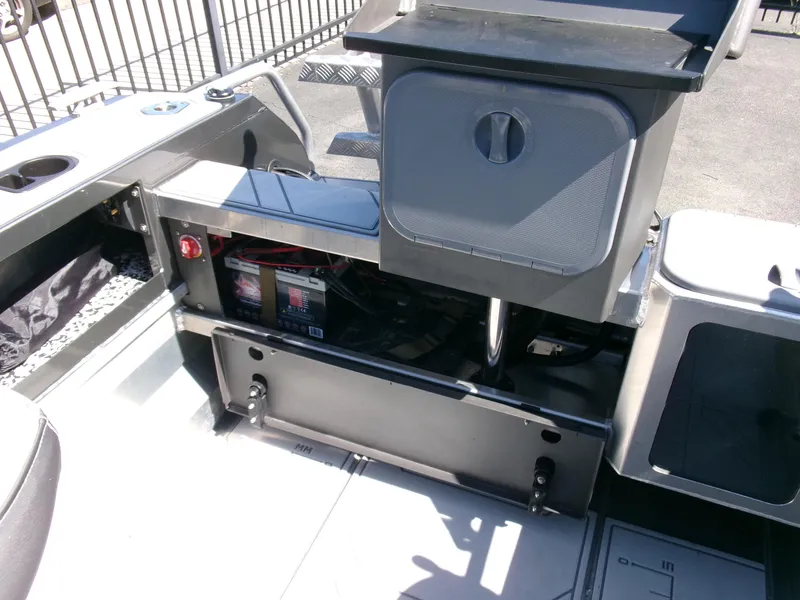 Slide: The Image of 2023 Stabicraft 1550 Frontier Profish series boat interior with storage compartments and battery. - 17