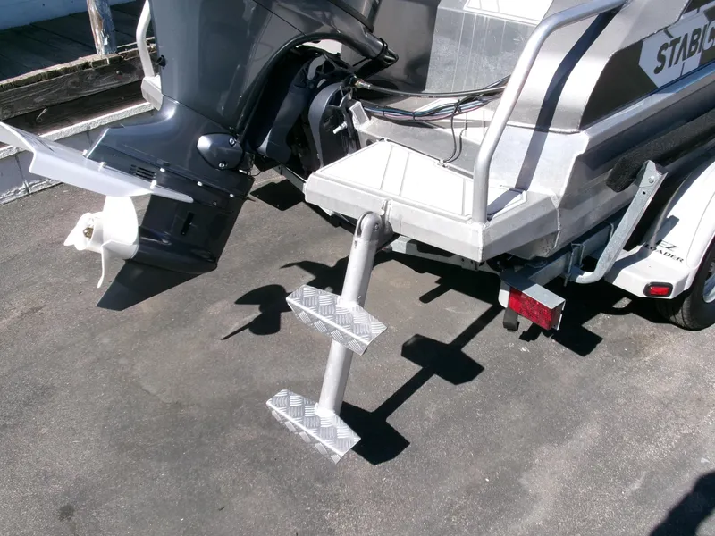 Slide: The Image of 2023 Stabicraft 1550 Frontier Profish boat with motor and rear step ladder. - 23