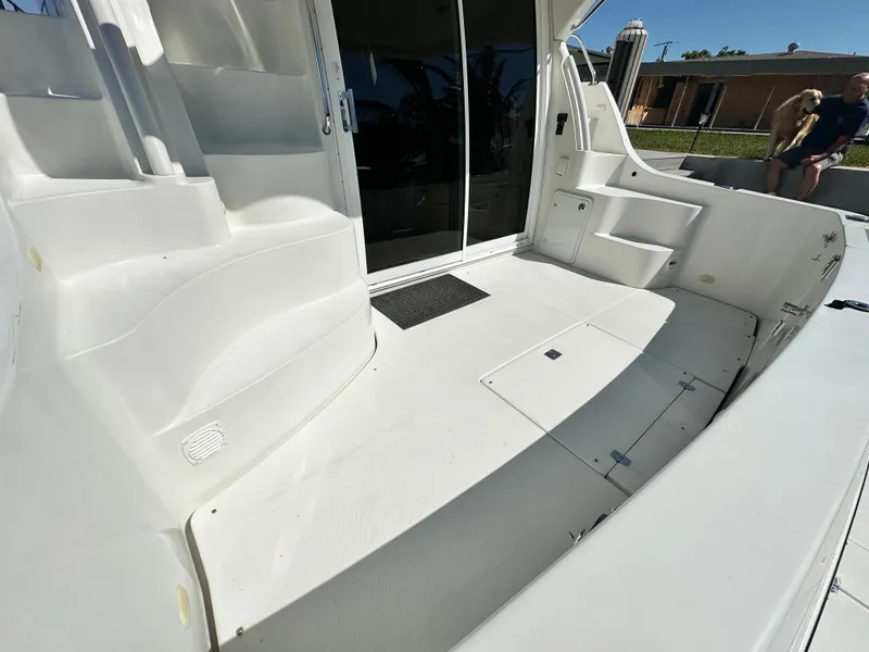 Slide: The Image of 2004 Carver 360 Sport Sedan boat deck with white seating and storage compartments. - 10