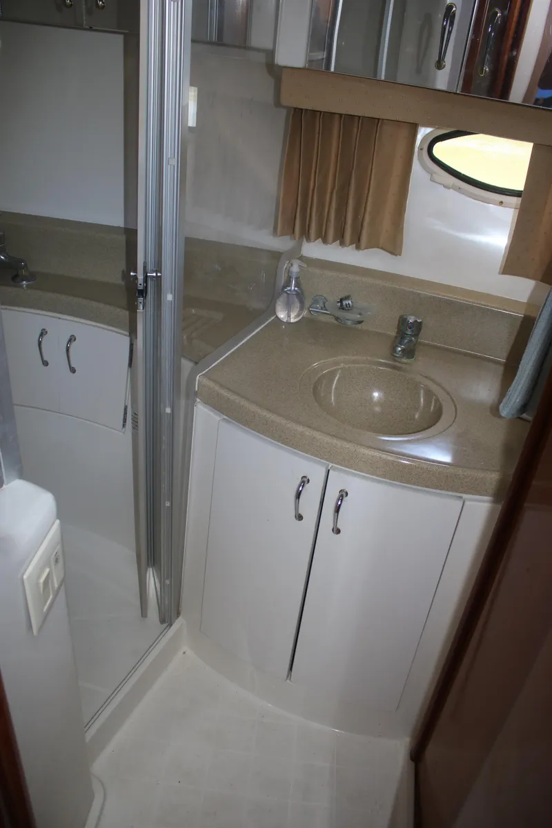 Slide: The Image of 2004 Carver 360 Sport Sedan bathroom with sink, mirror, and shower. - 16