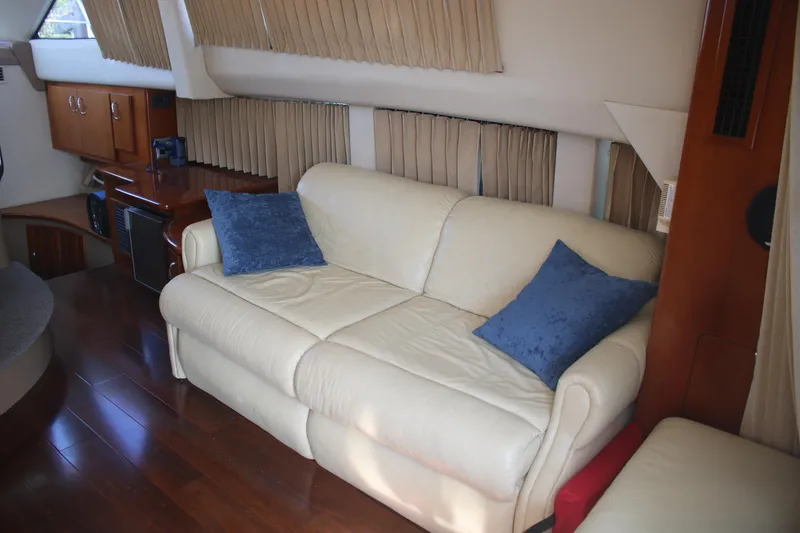 Slide: The Image of Interior of 2004 Carver 360 Sport Sedan with cream sofa and blue cushions. - 18