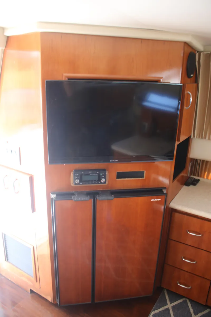 Slide: The Image of 2004 Carver 360 Sport Sedan interior with TV, stereo, and mini fridge. - 20