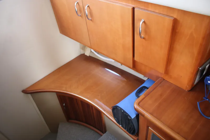 Slide: The Image of 2004 Carver 360 Sport Sedan interior with wooden cabinetry and desk area. - 23