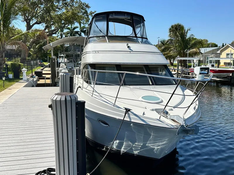 Slide: The Image of 2004 Carver 360 Sport Sedan docked by a sunny waterfront with palm trees. - 3