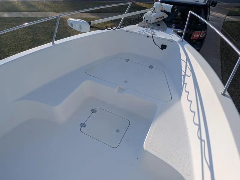 Slide: The Image of 2003 Pro-Line 22 Sport boat deck with storage compartments and railing. - 10