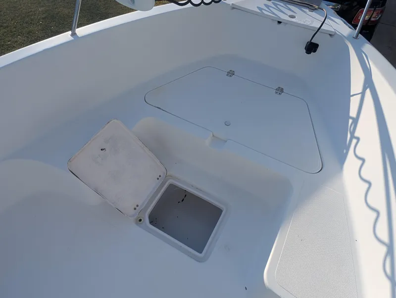 Slide: The Image of 2003 Pro-Line 22 Sport boat interior with open storage compartments. - 12