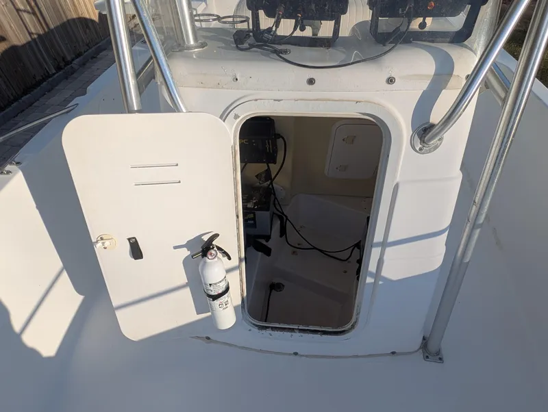 Slide: The Image of 2003 Pro-Line 22 Sport boat with open hatch and visible fire extinguisher. - 15