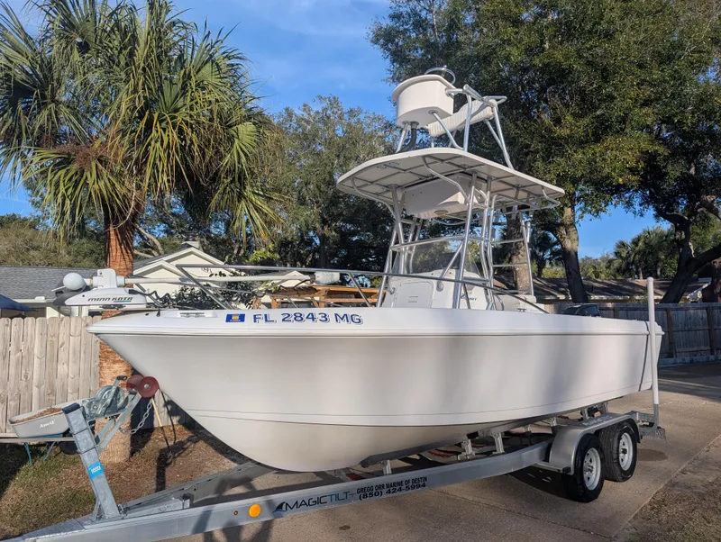 Slide: The Image of 2003 Pro-Line 22 Sport boat on trailer, parked outdoors near palm trees. - 2