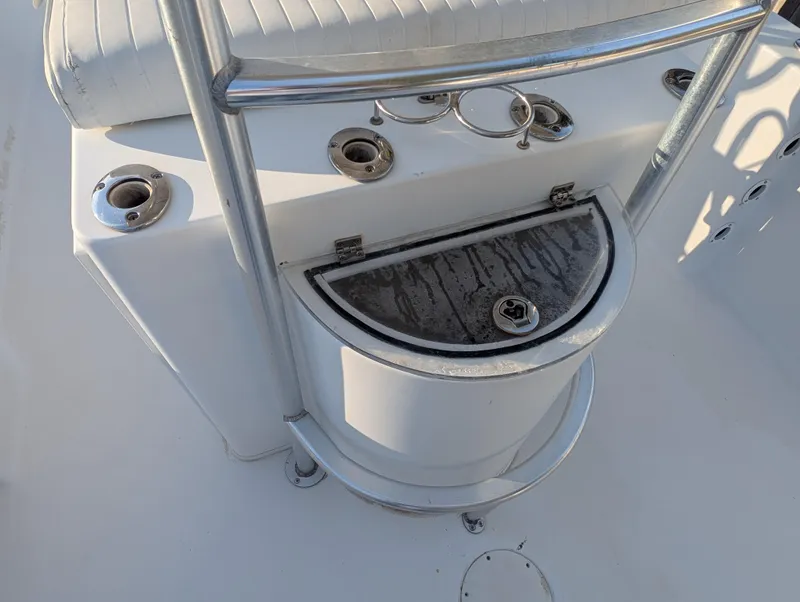 Slide: The Image of 2003 Pro-Line 22 Sport boat console with rod holders and storage compartment. - 22