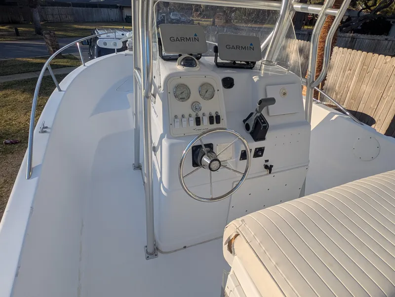 Slide: The Image of 2003 Pro-Line 22 Sport boat cockpit with Garmin navigation systems and steering wheel. - 23