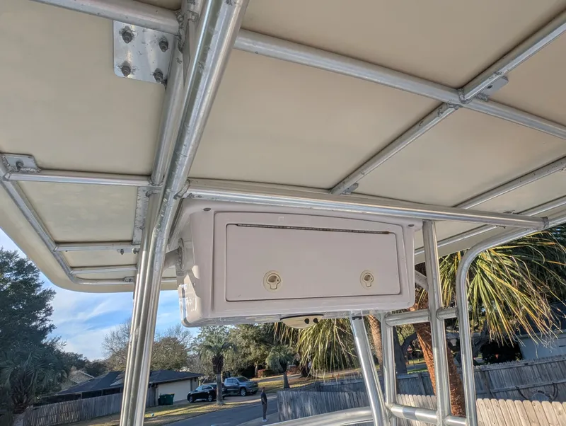 Slide: The Image of 2003 Pro-Line 22 Sport boat T-top with storage compartment, outdoor setting. - 24