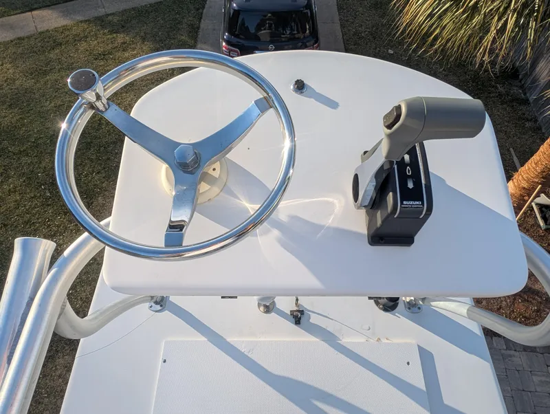 Slide: The Image of 2003 Pro-Line 22 Sport boat helm with steering wheel and throttle control. - 26
