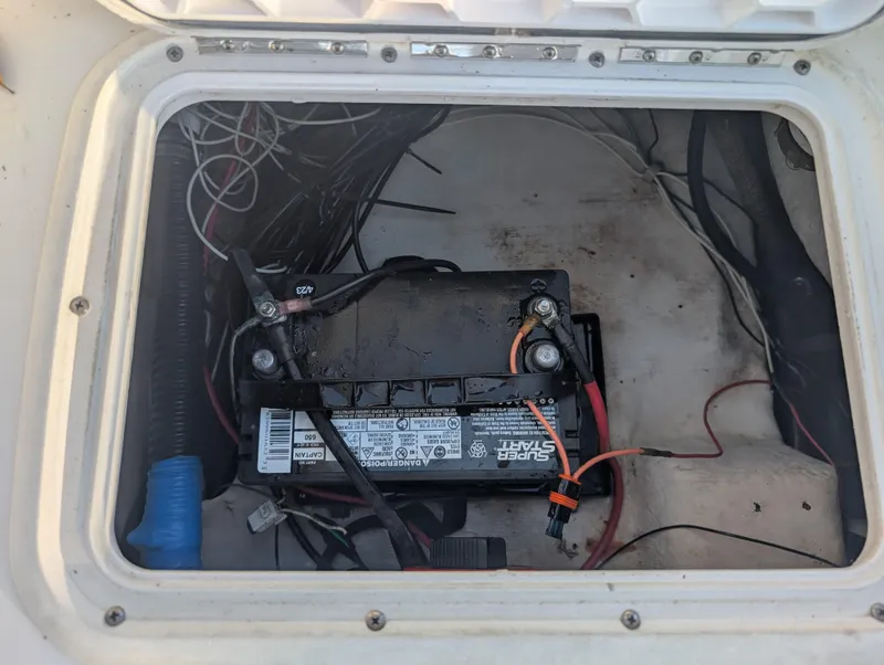 Slide: The Image of Battery compartment of a 2003 Pro-Line 22 Sport boat with wiring connections. - 30