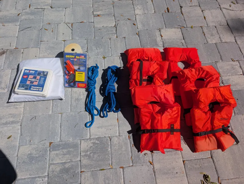 Slide: The Image of Safety gear for 2003 Pro-Line 22 Sport: life jackets, ropes, and emergency kit on pavement. - 31