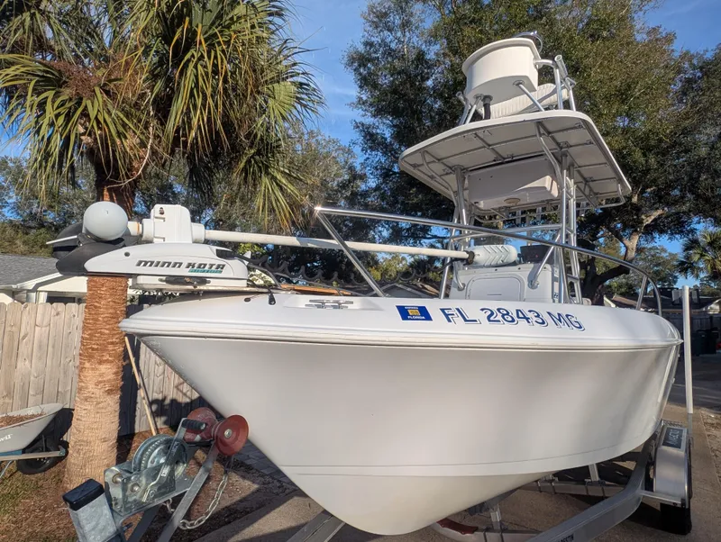 Slide: The Image of 2003 Pro-Line 22 Sport boat on trailer, parked near palm trees. - 6