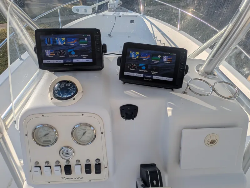 Slide: The Image of 2003 Pro-Line 22 Sport boat dashboard with navigation screens and gauges. - 8