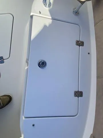 Slide: The Image of 2020 Sportsman Open 242 boat hatch with secure latch and hinges. - 13