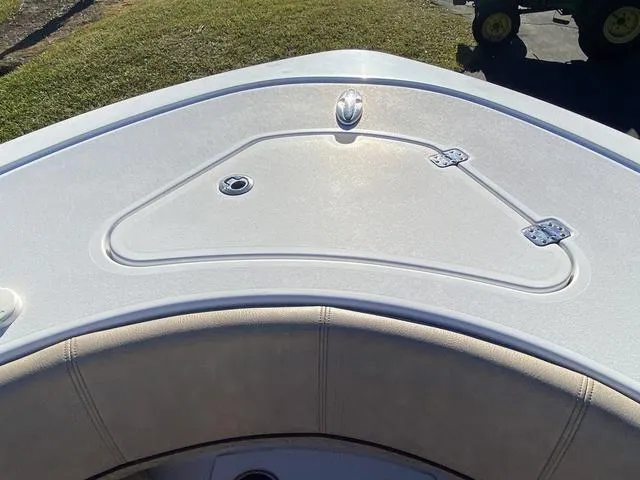 Slide: The Image of 2020 Sportsman Open 242 boat deck with storage hatch and cushioned seating. - 14