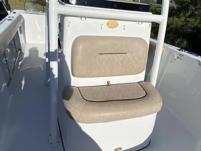 Slide: The Image of 2020 Sportsman Open 242 boat interior with beige cushioned seating and white console. - 17