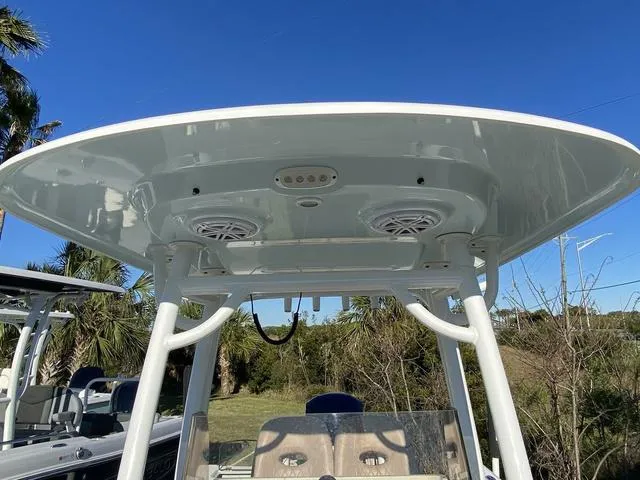 Slide: The Image of 2020 Sportsman Open 242 boat T-top with speakers and lights, set against a clear blue sky. - 19