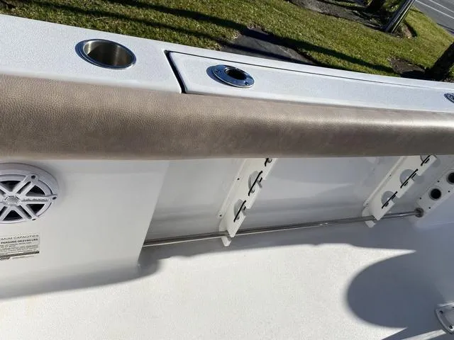 Slide: The Image of 2020 Sportsman Open 242 boat interior with rod holders and cup holder. - 26