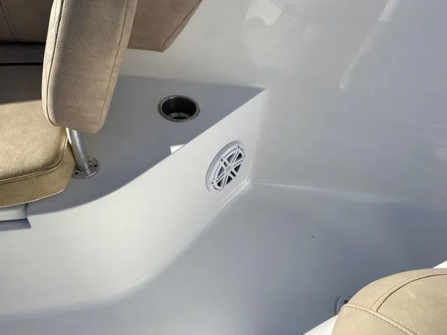 Slide: The Image of Interior of a 2020 Sportsman Open 242 boat, featuring seating and a speaker. - 30