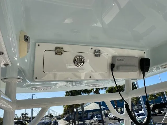 Slide: The Image of 2020 Sportsman Open 242 boat console with Garmin device and storage compartment. - 32