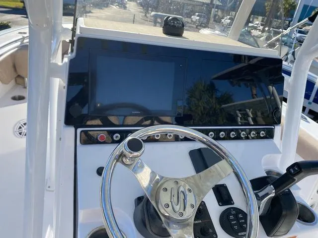 Slide: The Image of 2020 Sportsman Open 242 boat dashboard with steering wheel and control panel. - 33