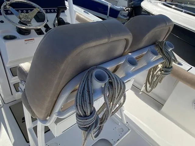Slide: The Image of 2020 Sportsman Open 242 boat seats with rope holders and steering console. - 35