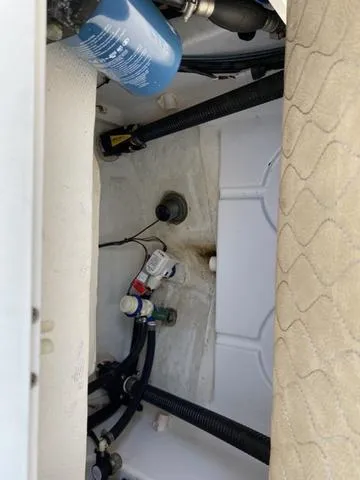 Slide: The Image of 2020 Sportsman Open 242 boat interior, showing mechanical components and wiring. - 49