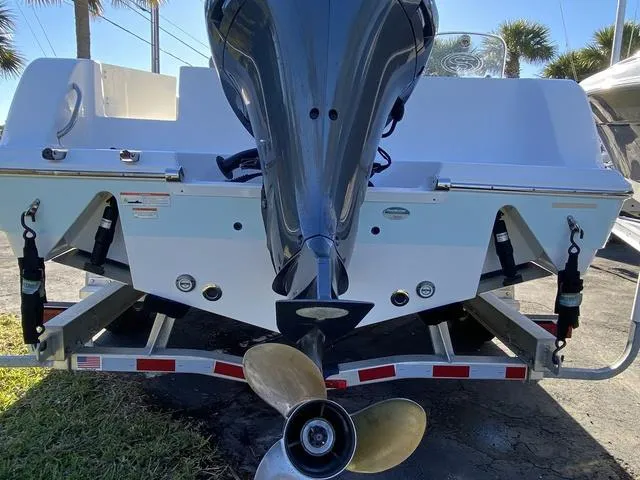 Slide: The Image of 2020 Sportsman Open 242 boat on trailer, rear view with outboard motor. - 7